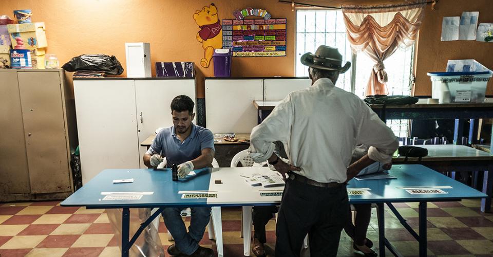 Un hombre ejerce su derecho al voto en una mesa electoral de un centro en Chimaltenango.